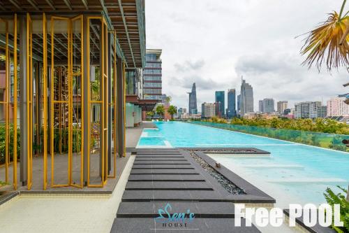 a swimming pool with a city skyline in the background at Sens House Saigon - Metropole Luxury Boutique in Ho Chi Minh City