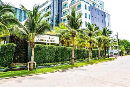 a street with palm trees in front of a building at Laguna Beach Resort 1 by BPS in Jomtien Beach
