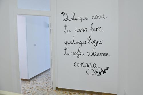 a wall sticker in a hallway with the wordsgraduate school im a real face at casa Venezia in Carovigno