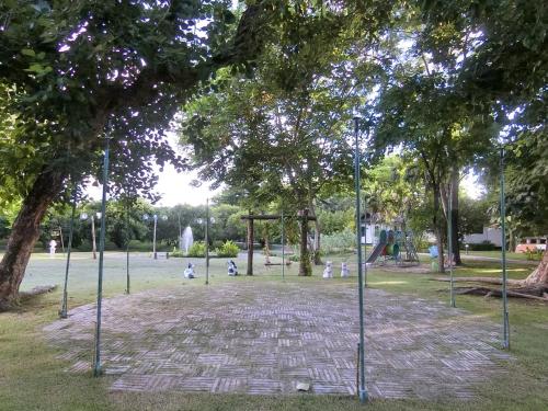 a park with a playground with trees and a swing set at AURA Park Resort in Ban Thung Sam Sao