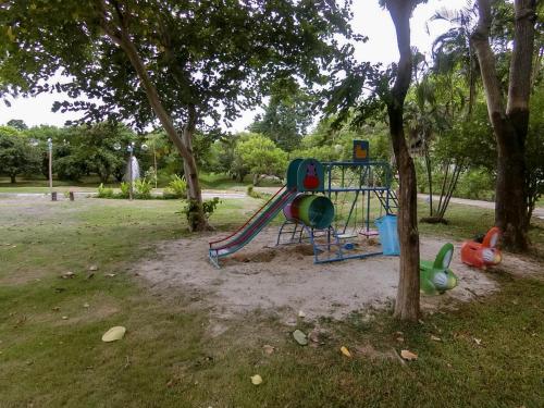 a playground with a slide in a park at AURA Park Resort in Ban Thung Sam Sao