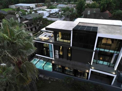 an aerial view of a house with a swimming pool at Futuristic Pool Villa with Stunning Mountain View in Chiang Mai