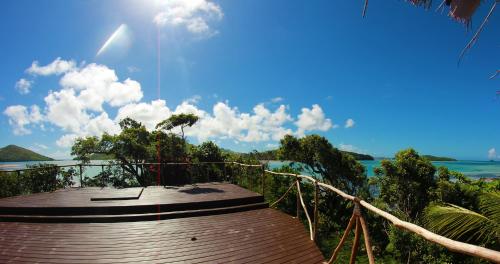 a wooden walkway with a view of the ocean at Navutu Stars Resort in Matayalevu