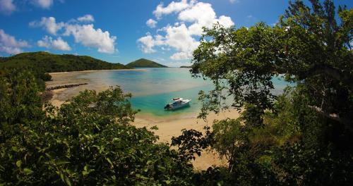 a boat in the water on a beach at Navutu Stars Resort in Matayalevu