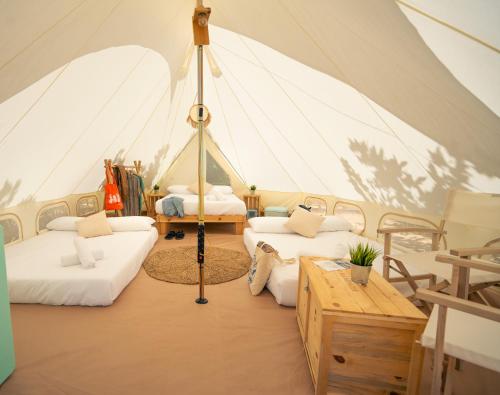 a room with two beds in a tent at Kampaoh Costa del Sol in Caserío Almayate Bajo
