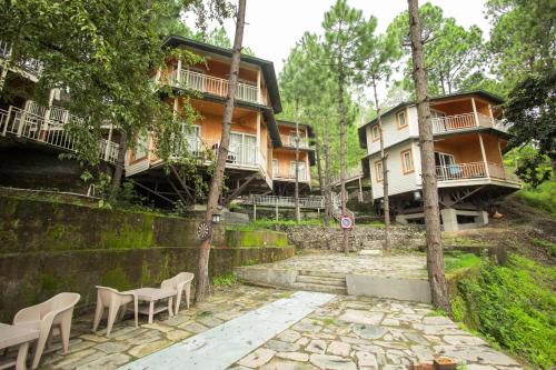 a building with tables and chairs in front of it at The Woods Retreat in Lansdowne
