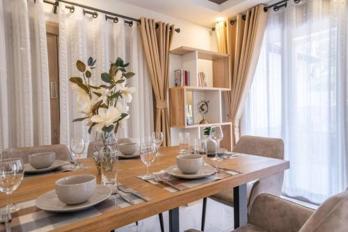 a dining room table with a vase of flowers on it at 5BR PoolVilla On the Old City Moat ⁜Best Location⁜ in Chiang Mai
