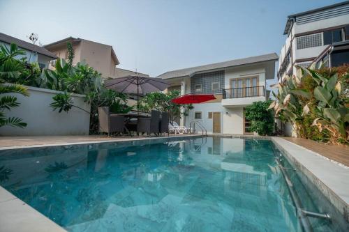 a swimming pool with blue water in front of a building at 5BR PoolVilla On the Old City Moat ⁜Best Location⁜ in Chiang Mai