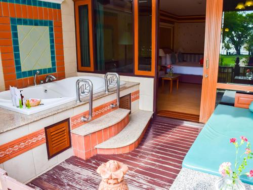 a bathroom with a tub and a sink at Asia Pattaya Hotel in Pattaya South