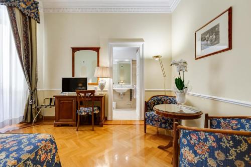 a living room with a couch and a table at Hotel Cellini in Rome