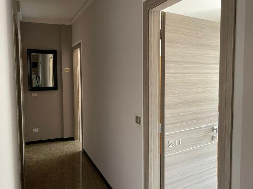 a door to a hallway with a mirror in a room at Albergo Tecla in Lazise