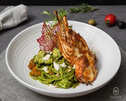 a plate of food with seafood and vegetables on a table at Gloud Hotel in Hanoi