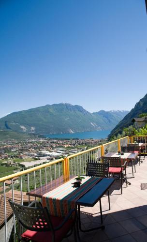 a patio with tables and chairs on a balcony at Albergo Deva in Riva del Garda