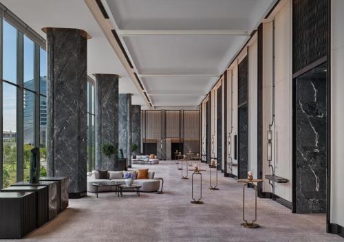 a rendering of a lobby with couches and tables at InterContinental Shenzhen WECC by IHG in Shenzhen