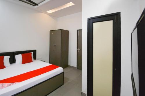 a bedroom with a bed and a mirror at Flagship White Solitaire in Ludhiana
