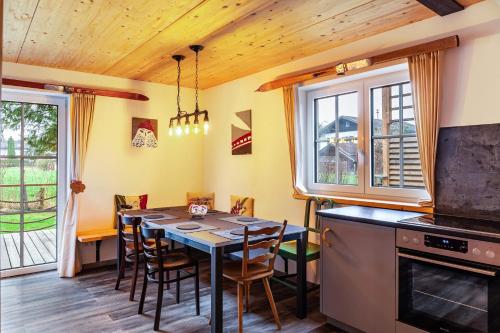 a kitchen with a table and chairs in a room at Chalet Rauschn 1 in Farchant