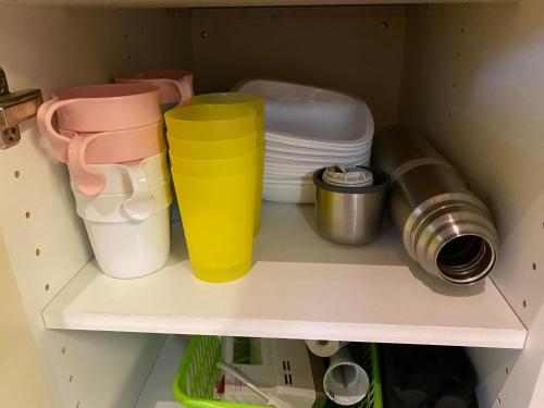 a shelf with some cups and plates on it at Fjällstuga i avskildhet med elbilsladdare in Idre