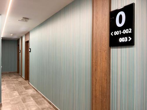 a sign on a wall in a hallway at Hotel MG Poniente in Las Palmas de Gran Canaria