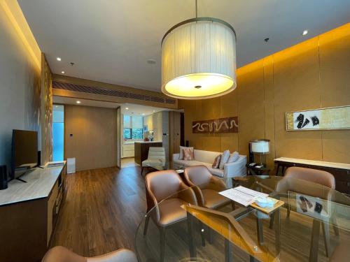 a lobby of a hotel with a table and chairs at The OCT Harbour, Shenzhen - Marriott Executive Apartments in Shenzhen