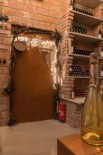 a room with a brick wall and a bottle of wine at Veltlin Bed & Wine in Valtice