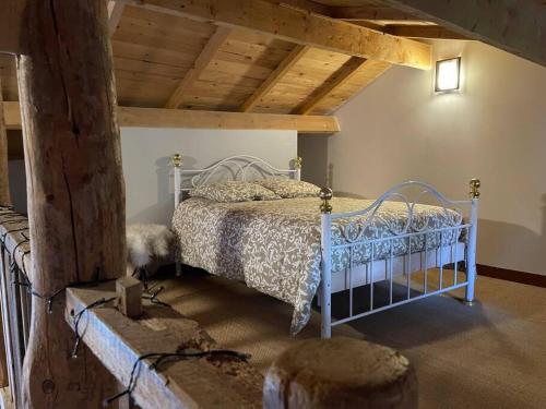 a bedroom with a bed in a room with wooden ceilings at La clé des champs de Laumont in Saint-Diéry