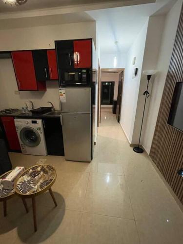 a kitchen with a refrigerator and a table in a room at apartment 60m 1bedroom for rent2 in Umm Uthainah