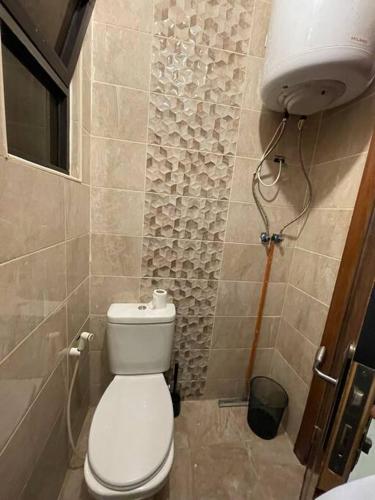 a bathroom with a white toilet in a room at apartment 60m 1bedroom for rent2 in Umm Uthainah