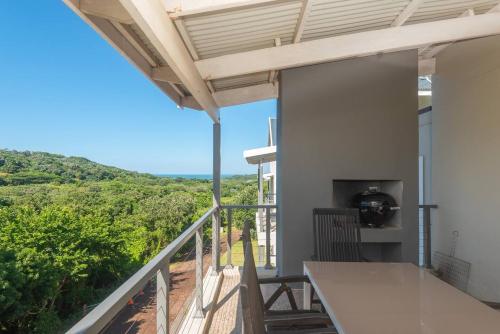 a balcony with a view of the ocean at Refined 3 Bedroom Apartment Princes Grant in Blythedale