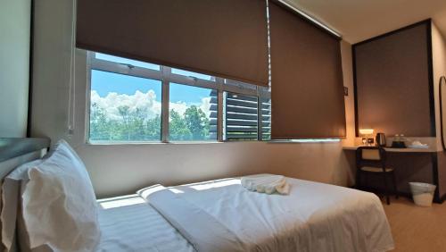 Кровать или кровати в номере Urban Inn, SP Saujana