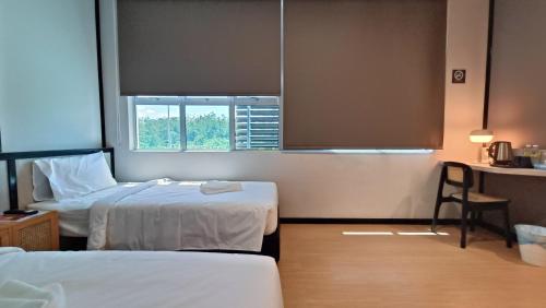 Кровать или кровати в номере Urban Inn, SP Saujana