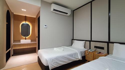 Кровать или кровати в номере Urban Inn, SP Saujana