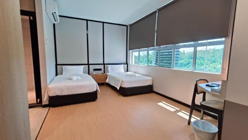 Кровать или кровати в номере Urban Inn, SP Saujana