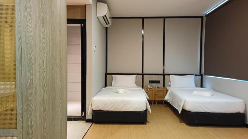 Кровать или кровати в номере Urban Inn, SP Saujana