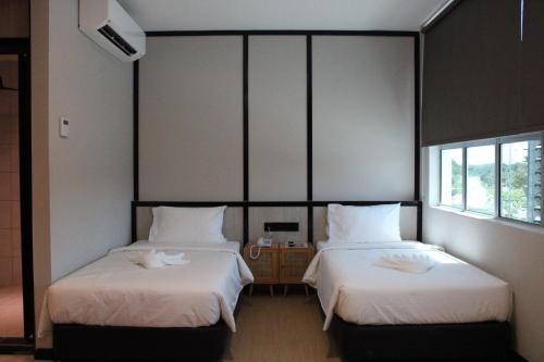 Кровать или кровати в номере Urban Inn, SP Saujana