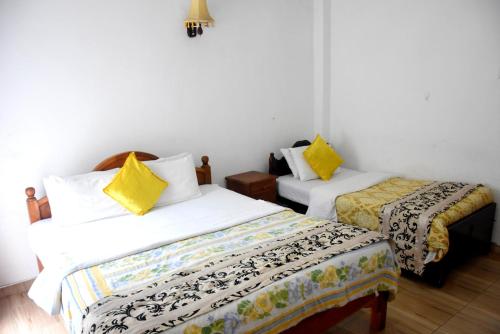 Pedro Resort & Bungalow Nuwara Eliya tesisinde bir odada yatak veya yataklar