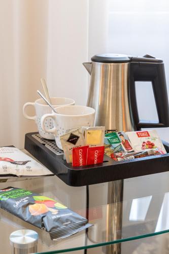 a table with a tea kettle on top of it at Erzsébet Királyné Szálloda in Gödöllő