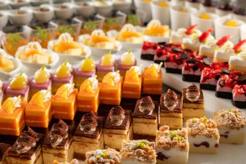 a bunch of different types of desserts on a table at Art Hotel Narita in Narita