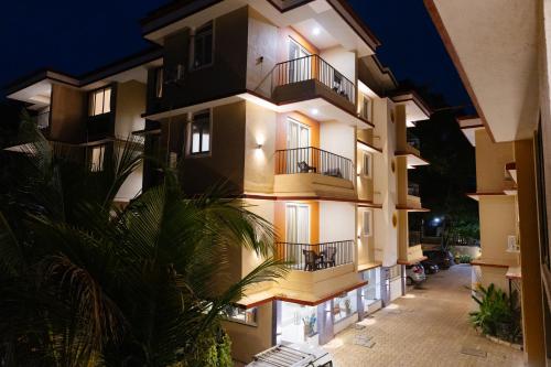 an apartment building with balconies at night at Kay's Calangute Resort Service Apartments in Calangute
