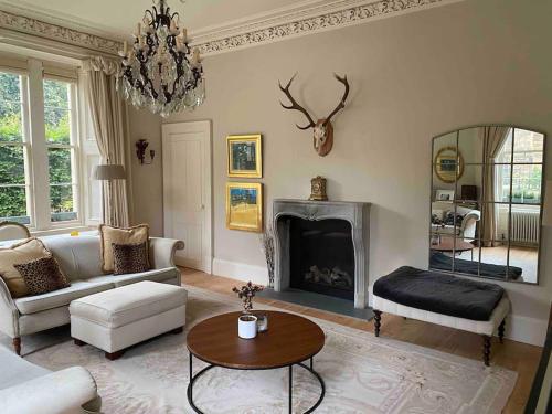 a living room with a couch and a fireplace at Home of Joy - 3 bedroom home with private garden in Glasgow