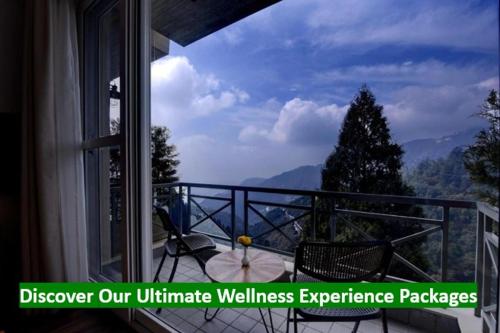 a balcony with a view of a mountain view at Yog Wellness Resort & Spa By Amritara in Mussoorie