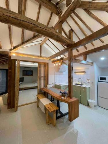 a kitchen with a wooden table in a room at Bow Hanok House in Gangneung