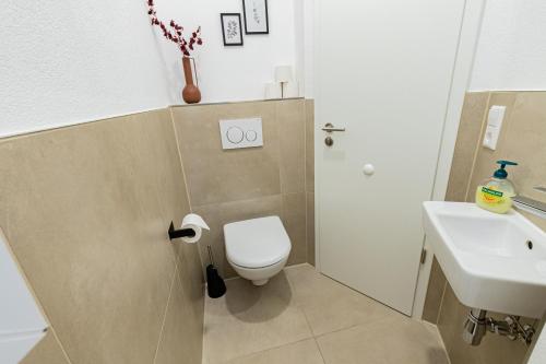 a bathroom with a toilet and a sink at LaMiaCasa City-Grande Family-Business Groups in Stuttgart