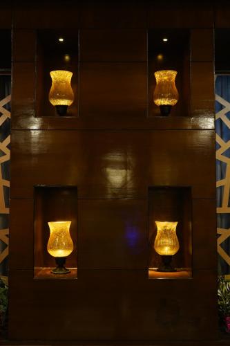 a group of lights on a wall at THE KALINGA INN in Rohtak