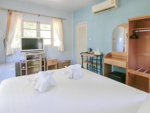 a bedroom with a white bed with towels on it at AURA Park Resort in Ban Thung Sam Sao
