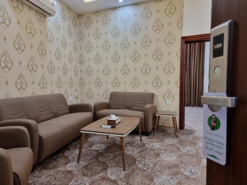 a living room with a couch and a table at Sheek Hotel in Erbil