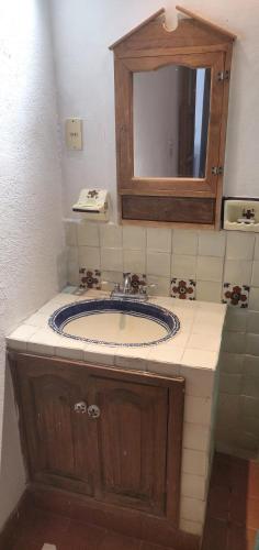 a bathroom with a sink and a mirror at Loft familial cosy in Guanajuato