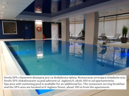 a large swimming pool in a building at Flatbook - City Center SPA Apartments Motlawa in Gdańsk