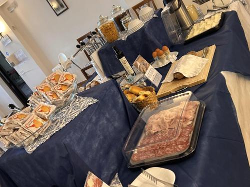 a table with a buffet of food on it at La Rosa Hotel - Selinunte in Marinella di Selinunte
