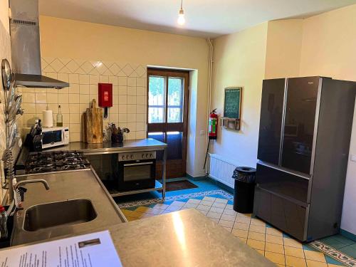 a kitchen with a refrigerator and a counter top at Hoeve de Knol in Holthees