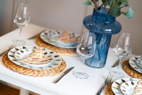 a table with plates of food and wine glasses at Heatherwood Cottage in New Scone